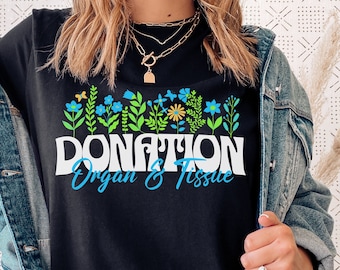 May include: Black t-shirt with a floral design and the text "DONATION Organ & Tissue" in white letters.