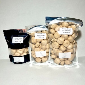 May include: Three bags of freeze-dried honey puffs in different sizes: 2 ounces, 4 ounces, and 8 ounces. The bags are clear and show the honey puffs inside.