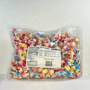 May include: A transparent bag filled with assorted fruit-filled sweets. The sweets are individually wrapped in colourful, patterned wrappers. The bag has a label that reads "ASSORTED FRUIT FILLED CANDIES" and "NET WT. 2.72 kg".