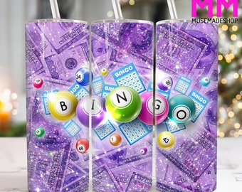 May include: Purple glitter tumbler featuring a design of dollar bills and bingo balls. The bingo balls have the letters B, I, N, G, and O on them. The tumbler comes with a straw.