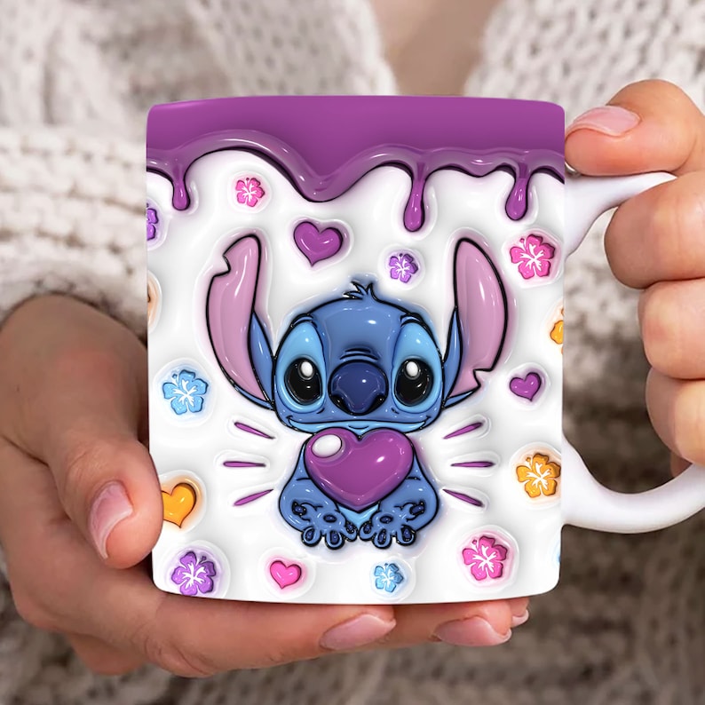 May include: A white ceramic mug with a purple rim and a design of Stitch from Lilo & Stitch holding a purple heart. The mug is decorated with pink, yellow, and blue flowers and hearts.