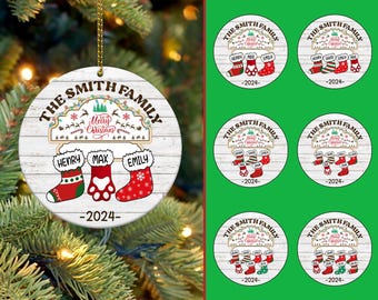May include: White round Christmas ornament with the text "The Smith Family" and a festive Christmas scene with stockings and the year "2024".