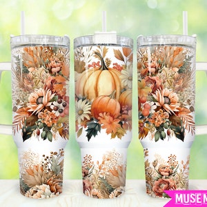 May include: Three stainless steel tumblers with white lids and handles. Each tumbler features a fall-themed design with pumpkins, leaves, and flowers in shades of orange, brown, and cream.