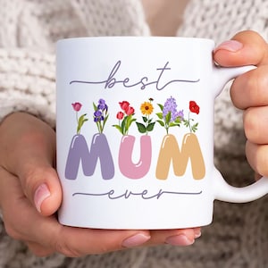 May include: White ceramic mug with the text "best mum ever" in purple script. The word "mum" is in large, colourful letters with flowers growing out of each letter.