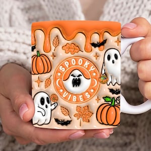 May include: Orange and white ceramic mug with a spooky vibes design. The mug features ghosts, pumpkins, bats, and leaves. The text "Spooky Vibes" is written in a circle with stars around it.
