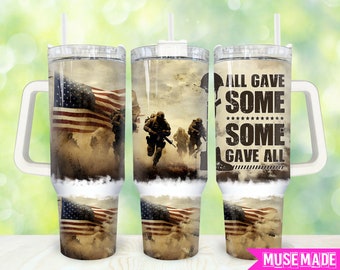 May include: A stainless steel tumbler with a white lid and handle. The tumbler features a design with an American flag, soldiers, and the text "All gave some, some gave all".