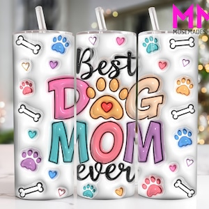 May include: White tumbler with a colourful design that says "Best Dog Mom Ever". The design includes paw prints, bones and hearts.