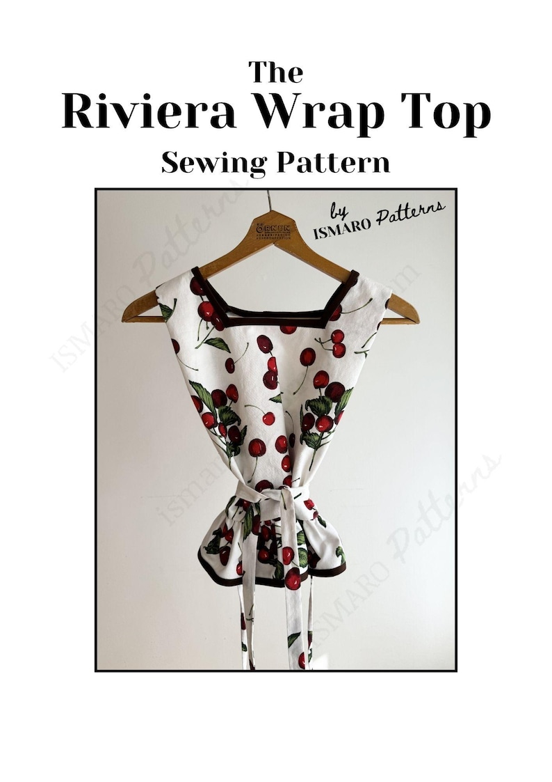 May include: A white wrap top sewing pattern with a cherry print, square neckline, and brown trim. The top is tied at the waist and hangs on a wooden hanger. Text at the top reads "The Riviera Wrap Top Sewing Pattern".