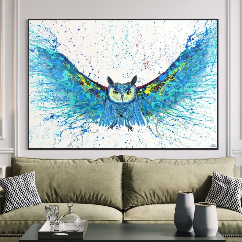 May include: A blue and green owl with its wings spread wide, painted in a splatter style on a white background.