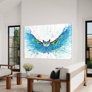 May include: A blue and green owl with its wings spread wide, painted in a splatter style on a white background.