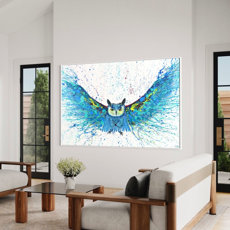 May include: A blue and green owl with its wings spread wide, painted in a splatter style on a white background.