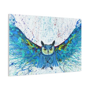 May include: A blue owl with yellow eyes is painted in a splatter style with blue, green, yellow, and red paint on a white background.