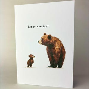 May include: A greeting card featuring a watercolour illustration of a brown bear and a smaller brown bear cub. The text "Love you mama bear!" is written in black ink.