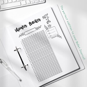 May include: A black and white printable shower tracker for a bullet journal. The tracker has a shower head icon and a calendar with 31 days. The text "shower tracker" is written in cursive.
