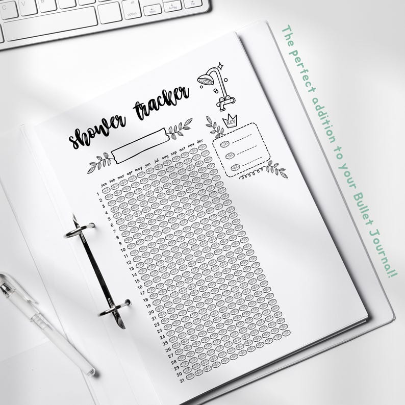 May include: A black and white printable shower tracker for a bullet journal. The tracker has a shower head icon and a calendar with 31 days. The text "shower tracker" is written in cursive.