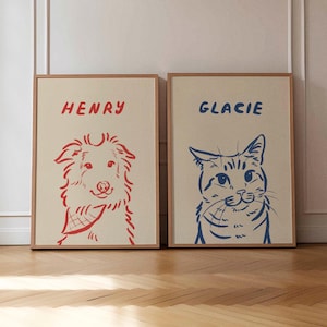 K&ouml;nnte beinhalten: Zwei gerahmte Kunstdrucke mit Tierportr&auml;ts. Einer zeigt eine rote Umrisszeichnung eines Hundes mit dem Namen "HENRY" dar&uuml;ber. Der andere zeigt eine blaue Umrisszeichnung einer Katze mit dem Namen "GLACIE". Beide Drucke haben einen cremefarbenen Hintergrund.