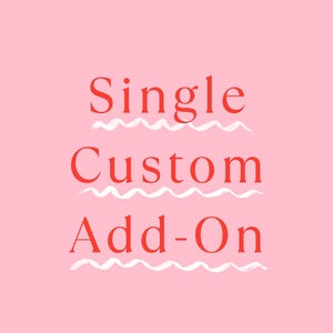 May include: A light pink graphic with the red text Single Custom Add-On centred in three lines. Each line of text is underlined with a white, hand-drawn wavy line. The overall design is simple, featuring bold red lettering against a solid pink background.