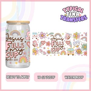May include: A 16 ounce clear tumbler with a wood lid and straw. The tumbler has a design with rainbows, flowers, butterflies, and the text "Jesus Fills My Cup" with the scripture reference "Psalm 23:5".