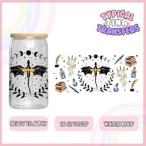 May include: A 16 ounce clear tumbler with a black dragon and moon phases design. The tumbler has a bamboo lid and straw. The design is also available as a separate sticker sheet with additional elements like books, feathers, and potion bottles.