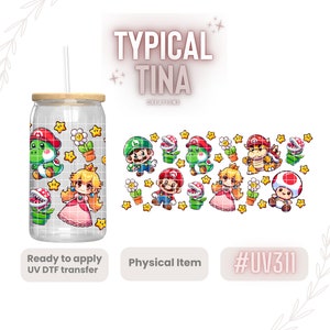 May include: A clear glass tumbler with a wooden lid and a straw. The tumbler has a design of various characters from the Super Mario Bros. video game series, including Mario, Luigi, Peach, Toad, and Yoshi. The design is printed on a white background with stars and flowers. The text "#UV311" is visible in the lower right corner of the image.