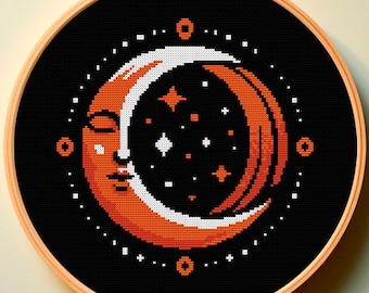Op de afbeelding: Een zwarte borduurring met een wit en oranje halve maan ontwerp met een gezicht en sterren. De maan is omringd door een cirkel van witte stippen.
