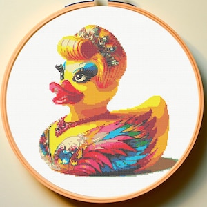 May include: A yellow rubber duck with a colorful feathered design and a crown on its head. The duck is wearing a necklace and has a bright red beak and eyes.