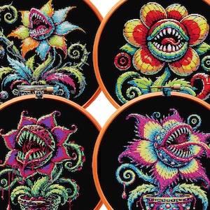 May include: Four embroidery hoops with black fabric and colorful cross-stitch designs of carnivorous plants with toothy mouths. The plants are in various shades of red, orange, yellow, green, blue, and purple.