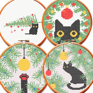 May include: Four circular wooden embroidery hoops containing cross-stitch patterns of black cats in holiday settings. Designs include a cat with a Christmas tree, a cat in a wreath, a cat paw reaching for an ornament, and a cat sitting under branches.