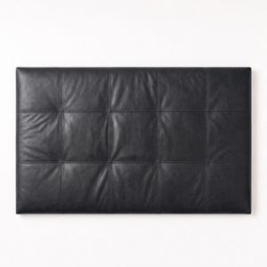 Puede incluir: Un cabecero rectangular tapizado en cuero negro con un patrón de cuadrícula de doce secciones cuadradas. La superficie muestra pliegues naturales y texturas visibles en cada panel cosido, creando una apariencia estructurada y uniforme.