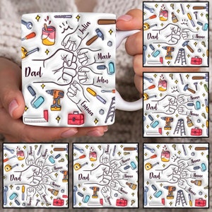 May include: White ceramic mug featuring a design with tools, fists, and the word "Dad." The mug includes names like Julia, Mark, John, and Emma. Additional tools and stars are scattered around the design.