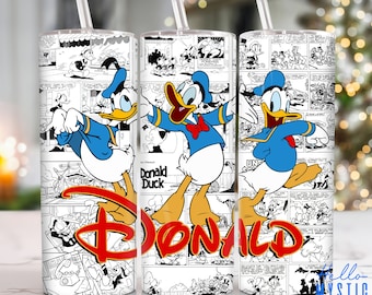 May include: A white tumbler with a black and white comic book design featuring Donald Duck. The tumbler has a clear lid and a straw. The text "Donald Duck" is visible on the tumbler.