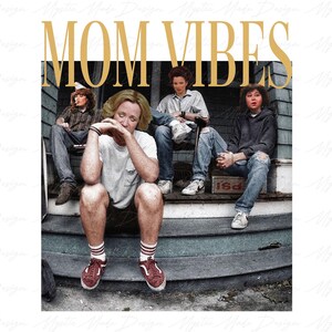 May include: A group of four people sitting on a porch steps. The people are wearing casual clothing. The text "MOM VIBES" is written in gold letters above the people.