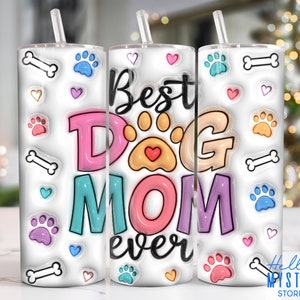 May include: A white tumbler with a colourful design that says "Best Dog Mom Ever". The design includes paw prints, hearts and bones.