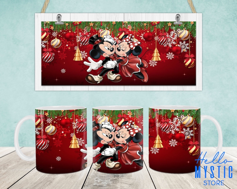 May include: Two white ceramic mugs with red and green Christmas designs. The mugs feature Mickey Mouse and Minnie Mouse dressed in holiday attire. The mugs are surrounded by snowflakes and ornaments.