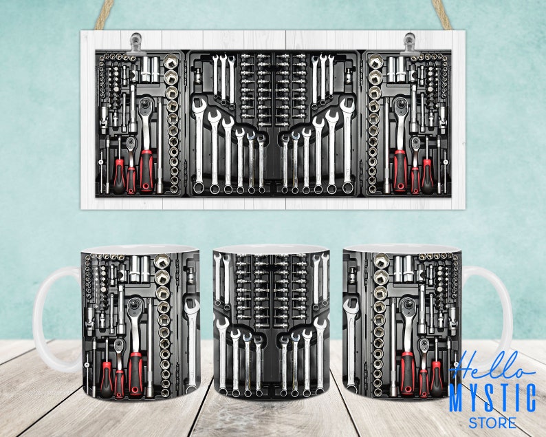 May include: Two white ceramic mugs with a design of a tool box filled with wrenches and screwdrivers. The design is in black and gray with red accents.
