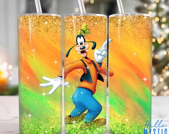 May include: A stainless steel tumbler with a colorful design featuring a cartoon character. The design includes a green, orange, and yellow background with gold glitter. The cartoon character is Goofy, wearing a red shirt, blue pants, and a brown vest. The tumbler has a straw.
