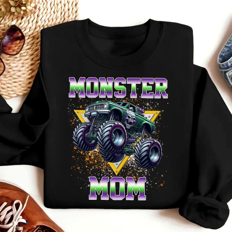 May include: Black sweatshirt with a green monster truck graphic and the text "Monster Mom" in purple and green.