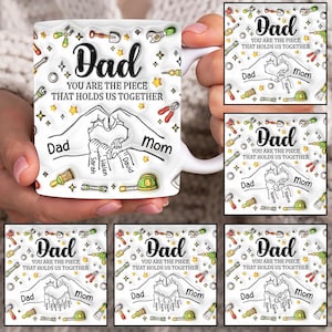 May include: White ceramic mug with a black outline of hands forming a heart shape. The text "Dad You Are The Piece That Holds Us Together" is printed on the mug. The hands have names written on the fingers, including "Dad", "Mom", "Sarah", "Helen", and "David". The mug is surrounded by a pattern of tools and stars.
