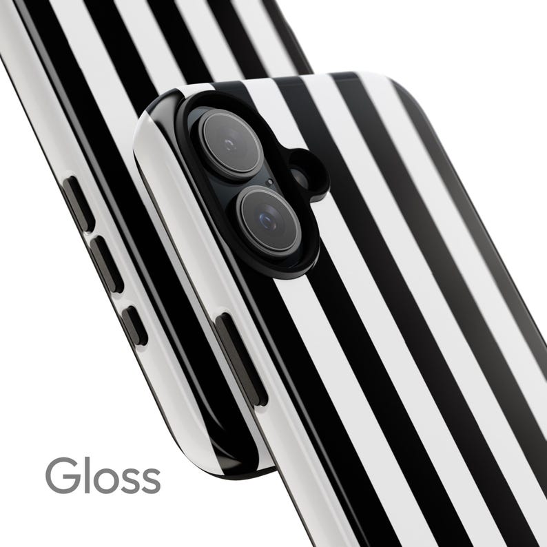 May include: Glossy phone case with a black and white striped pattern. The case has a dual-lens camera cutout and the word "Gloss" is printed on the lower left corner. The case is designed to protect the phone from scratches and damage.