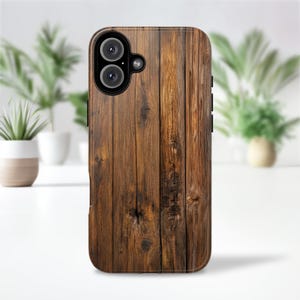 May include: A brown wooden phone case with a vertical wood grain pattern. The case has a dual-lens camera cutout and side buttons. The design mimics the look of natural wood, offering a rustic aesthetic.