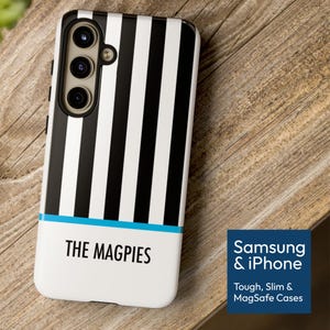 May include: A black and white striped phone case with the text "THE MAGPIES" in black. The case has a blue stripe and a camera module. The case is for Samsung and iPhone.