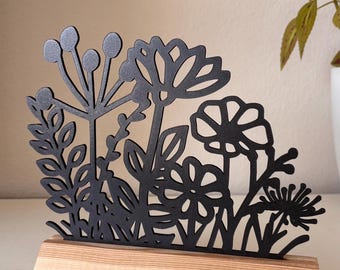 Flower meadow display stand for spring and summer with beautiful flowers in a modern design, including wooden blocks for standing.