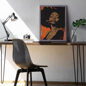 May include: A framed illustration of a woman with an afro hairstyle, wearing a black top and holding a lit cigar. The background is a warm orange color.