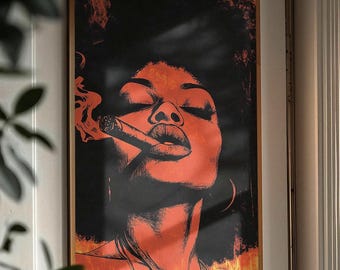May include: A framed art print featuring a woman with closed eyes smoking a cigar. The artwork uses a color palette of black and orange, with the woman's face and neck in orange tones. The background is black with orange accents, and the frame is gold.