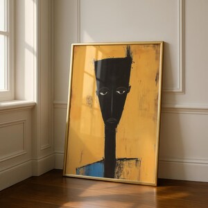 May include: A framed vertical wall art print featuring a stylised, elongated black figure with a flat-topped head and neutral expression set against a textured, mustard-yellow background with a small blue accent at the bottom of the figure's torso.