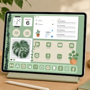 May include: A tablet computer displaying a sage green digital interface with custom app icons, a calendar widget showing Wednesday March 6, a water intake tracker, and a notification panel listing Etsy transactions on a light wood desk surface.