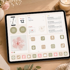 May include: A tablet displaying a digital interface with a soft beige and sage green color palette. The screen features widgets for a clock, calendar, to-do list, and Etsy transaction notifications, alongside various app icons and a floral graphic.