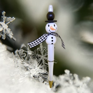 Snowman pens in black ink, ballpoint. Wooden beads