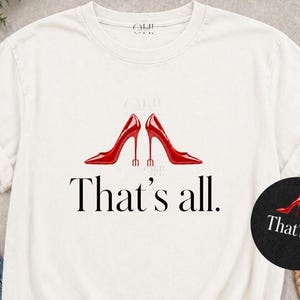 May include: White t-shirt featuring a graphic of two red high-heeled shoes and the text "That's all." A small, circular graphic with the same design is also present. The shirt is digitally downloadable.