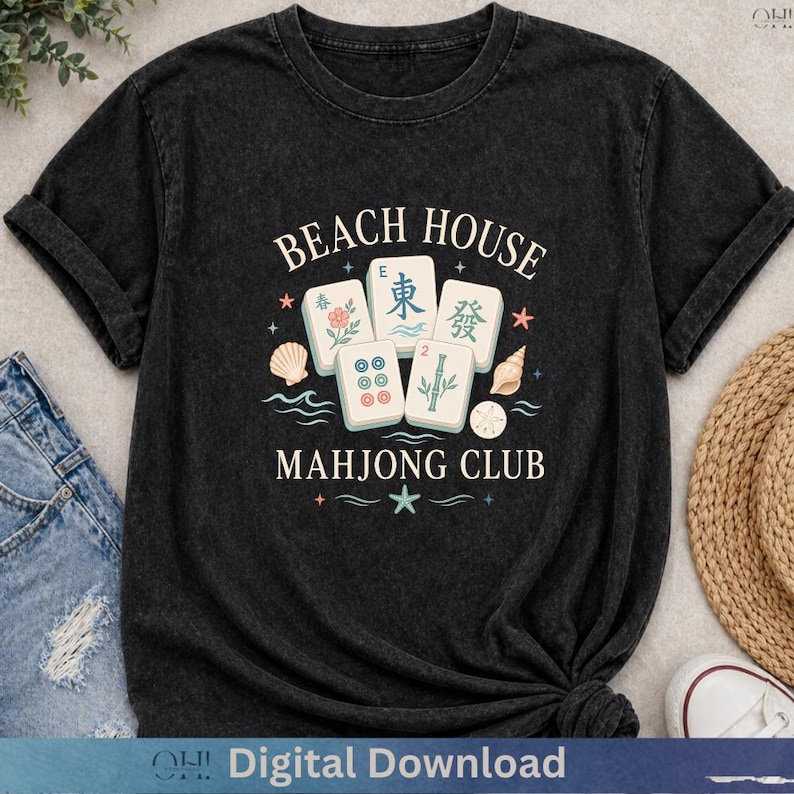May include: Black t-shirt with the text "BEACH HOUSE MAHJONG CLUB" and illustrations of Mahjong tiles, seashells, and stars. The shirt has a crew neck and rolled-up sleeves. The words "Digital Download" are at the bottom.